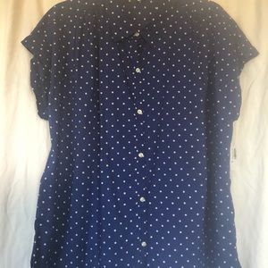 Short sleeve blue and white polka dot shirt.